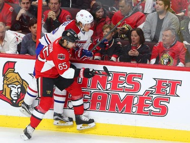 Erik Karlsson of the Ottawa Senators hits Jacob De La Rose of the Montreal Canadiens during first period action.