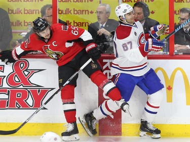 Erik Karlsson  of the Ottawa Senators hits Max Paciorettyof  the Montreal Canadiens during first period action at Canadian Tire Centre in Ottawa, April 19, 2015.
