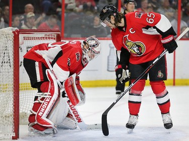 Erik Karlsson offers words of encouragement to Andrew Hammond during a penalty kill in the second period.