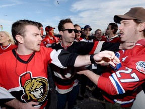 Fans get into a shoving match ahead of game 3 of first round Stanley Cup NHL playoff hockey between the Ottawa Senators and the Montreal Canadiens in Ottawa on Sunday.