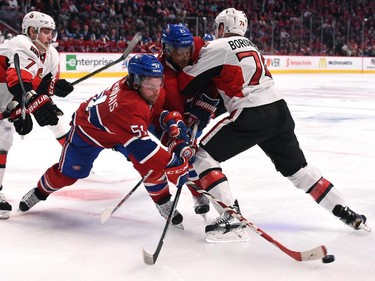 David Desharnais #51 and Devante Smith-Pelly of the Montreal Canadiens fight for the puck against Mark Borowiecki #74  of Ottawa Senators in Game Two of the Eastern Conference Quarterfinals during the 2015 NHL Stanley Cup Playoffs at the Bell Centre on April 17, 2015 in Montreal, Quebec, Canada.