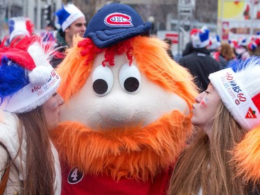 Hab fans Laurence Beaudet and Alice Campeau (R) give Youppie a big kiss as the Ottawa Senators get set to take on the Montreal Canadiens at the Bell Centre in Montreal for Game 5 of the NHL Conference playoffs on Friday evening.
