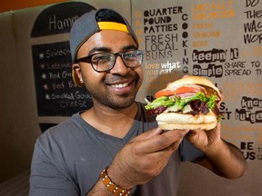 Jamal Bhuya, co-owner of Burgers n' Fries Forever on Bank Street, with the hot and spicy Hammond Burger.