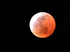 A total lunar eclipse is seen in Utsunomiya in Tochigi prefecture, 100km north of Tokyo on April 4, 2015. Sky-gazers in part of the Pacific Rim enjoyed an "unusually brief" total eclipse of the Moon.