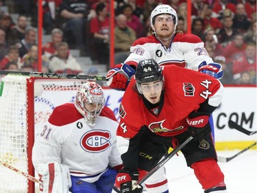 Jean-Gabriel Pageau of the Ottawa Senators is hit from behind by Jeff Petry of the Montreal Canadiens as Carey Price looks on during second period of NHL action at Canadian Tire Centre in Ottawa, April 26, 2015.