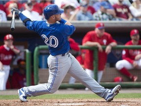 In this March 7, 2015 photo, Toronto Blue Jays third baseman Josh Donaldson (20) hits a solo home run against the Philadelphia Phillies during the fourth inning of a spring training baseball game in Clearwater, Fla.