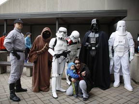 Julie and Sebastian Gaudet pose for a picture with Star Wars characters at the super hero themed 24th annual MS Walk at Tunney's Pasture on April 26, 2015.