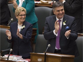 Ontario Finance Minister Charles Sousa and Premier Kathleen Wynne before tabling the provincial budget at Queen's Park in Toronto on Thursday, April 23, 2015.