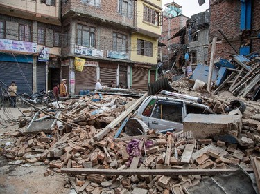 A taxi is buried under debris from a collapsed building in Thamel following an earthquake on April 25, 2015 in Kathmandu, Nepal. A major 7.8 earthquake hit Kathmandu mid-day on Saturday, and was followed by multiple aftershocks that triggered avalanches on Mt. Everest that buried mountain climbers in their base camps. Many houses, buildings and temples in the capital were destroyed during the earthquake, leaving hundreds dead or trapped under the debris as emergency rescue workers attempt to clear debris and find survivors.