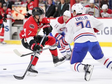 Kyle Turris loses his footing with Alexei Emelin, right, closing the gap in the first period.