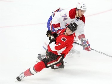 Kyle Turris of the Ottawa Senators is hit by Alexei Emelin of the Montreal Canadiens during first period action.