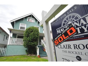 A house sports a For Sale/Sold sign in Vancouver, B.C., June 21, 2012.