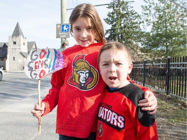 Lucy Nichols, 7, and her brother William, 4, with a home made sign along the Sens Mile as Sens fans pour onto the Sens Mile along Elgin St and the Sens Square in Byward Market to watch Friday's game between Montreal Canadiens and Ottawa Senators being played in Montreal.