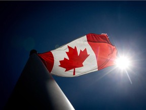 A Canadian flag flies in the wind at Granville Island in Vancouver, B.C., on Monday, June 30, 2014.