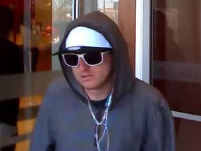 Ottawa police released this photo of a man wanted in four bank robberies between March 24 and 31st. The man has prominent earlobes stretched with 'gauges'.