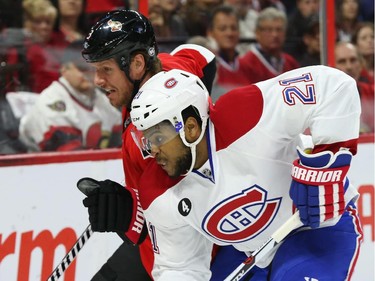 Marc Methot of the Ottawa Senators battles against Devante Smith-Pelly of the Montreal Canadiens during first period of NHL action at Canadian Tire Centre in Ottawa, April 26, 2015.