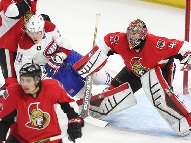 Marc Methot of the Ottawa Senators hits Brendan Gallagher  of the Montreal Canadiens as Craig Anderson looks on during first period action at Canadian Tire Centre in Ottawa, April 19, 2015.