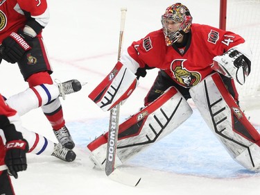 Marc Methot of the Ottawa Senators hits Brendan Gallagher  of the Montreal Canadiens as Craig Anderson looks on during first period action at Canadian Tire Centre in Ottawa, April 19, 2015.