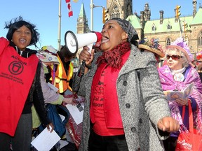 Marie Lourdes, who works at a low-wage job, chants at a rally to raise minimum wage in downtown Ottawa Wednesday for local ACORN chapters. ACORN - the Association of Community Organizations for Reform Now - wants the issue of raising minimum wage to be a key issue with the federal election approaching. About 40 people attended the rally near Parliament Hill.  (Julie Oliver / Ottawa Citizen)
