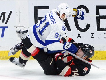 Ottawa Senators' Mark Borowiecki gets tangled up with Tampa Bay Lightning Steven Stamkos during first period NHL action.