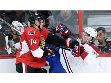 Ottawa Senators forward Mark Borowiecki (74) hits Montreal Canadiens defenceman Tom Gilbert (77) during the first period of game 3 of first round Stanley Cup NHL playoff hockey action in Ottawa on Sunday, April 19, 2015.