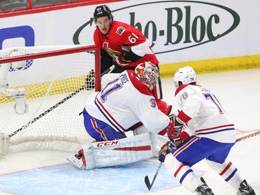 Mark Stone of the Ottawa Senators tries to find the open man as P.K. Subban and Carey Price of the Montreal Canadiens look on during first period action.
