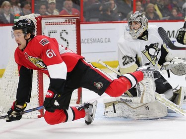 Mark Stone trips over goalie Marc-Andre Fleury in the third period as the Ottawa Senators take on the Pittsburgh Penguins in NHL action at Canadian Tire Centre in Ottawa. Assignment - 118582 Photo taken at 20:33 on April 7. (Wayne Cuddington / Ottawa Citizen)