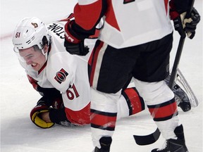Ottawa Senators right wing Mark Stone (61) grimaces after being slashed by Montreal Canadiens defenseman P.K. Subban (76) during second period of Game 1 NHL first round playoff hockey action on Wednesday, April 15, 2015, in Montreal. The Senators say Stone has suffered a microfracture of his right wrist, and his status is unknown for the rest of the Senators' first-round playoff series.