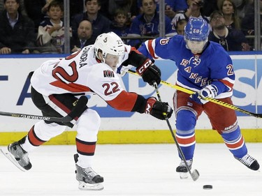 Ottawa Senators right wing Erik Condra (22) and New York Rangers right wing Martin St. Louis (26) fight for the puck during the first period of an NHL hockey game, Thursday, April 9, 2015, at Madison Square Garden in New York.
