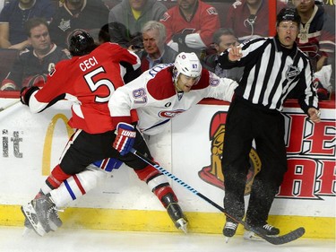Ottawa Senators' Cody Ceci (5) gets tangled up with Montreal Canadiens' Max Pacioretty (67) during the second period of an NHL Stanley Cup playoff hockey game, Sunday April 26, 2015, in Ottawa.
