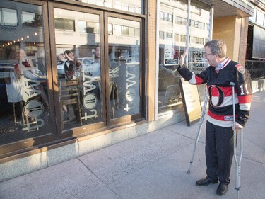 Mayor jim Watson waves to some diners as hockey fans head to the Sensmile on Elgin Street to watch the Ottawa Senators take on the Montreal Canadiens on television in game 1 of the playoffs.
