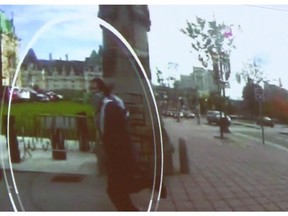 Michael Zehaf Bibeau is shown carrying a gun while running towards Parliament Hill in Ottawa on Wednesday, Oct. 23, 2014, in a still taken from video surveillance in this handout photo.