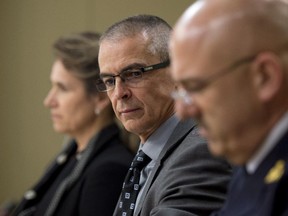 CSIS director Michel Coulombe (centre) waits with RCMP deputy commissioner Mike Cabana (right) and Greta Bossenmaier, Communications Security Establishment chief, to appear at the Senate national security committee to discuss the anti-terrorism act, Bill C-51 in Ottawa, Monday, April 20, 2015.