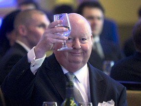 Senator Mike Duffy holds up his glass during the Maritime Energy Association's annual dinner in Halifax on Wednesday, Feb. 6, 2013. Duffy represents Prince Edward Island in the Senate but there is some controversy about his residency relating to housing allowances .THE CANADIAN PRESS/Devaan Ingraham ORG XMIT: POS2013020710252273