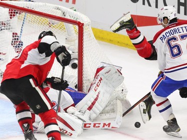 Milan Michalek of the Ottawa Senators tries to get the rebound from Carey Price of the Montreal Canadiens as Bobby Ryan is hit by Max Pacioretty during second period action.