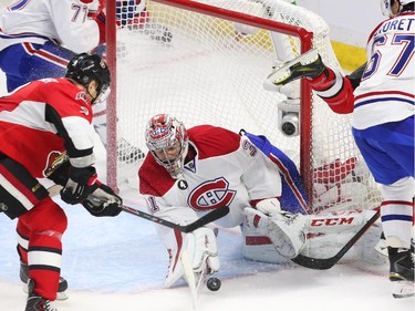 Milan Michalek of the Ottawa Senators tries to get the rebound from Carey Price of the Montreal Canadiens as Bobby Ryan is hit by Max Pacioretty during second period action.