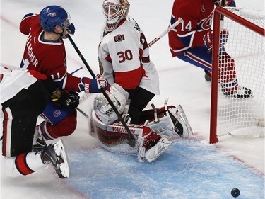 Montreal Canadiens' Brendan Gallagher, left, slides into Ottawa Senators' goalie, Andrew Hammond, after Canadiens' Tomas Plekanc, 14, scores during the second period of NHL playoff action at the Bell Centre in Montreal Wednesday April 15, 2015.