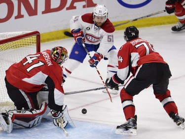 Montreal Canadiens' David Desharnais (51) drives to the net as Ottawa Senators' Mark Borowiecki (74) and Craig Anderson (41) defend during first period NHL playoff action in Ottawa, Sunday, April 26, 2015.