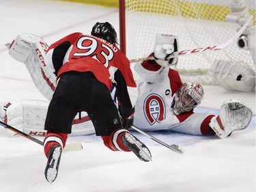 Montreal Canadiens goalie Carey Price sprawls in front of a leaping Ottawa Senators' Mika Zibanejad (93) during third period NHL playoff action in Ottawa, Sunday, April 26, 2015.