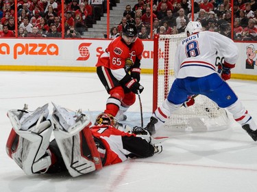 Goaltender Craig Anderson #41 dives to stop Brandon Prust #8 of the Montreal Canadiens as teammate Erik Karlsson #65 of the Ottawa Senators tries to defend in Game Six of the Eastern Conference Quarterfinals during the 2015 NHL Stanley Cup Playoffs at Canadian Tire Centre on April 26, 2015 in Ottawa, Ontario, Canada.