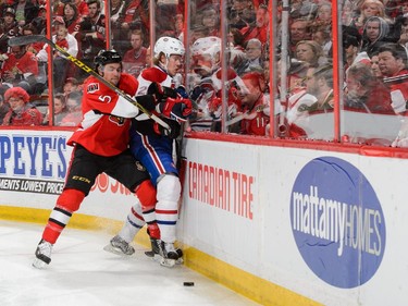 Cody Ceci #5 of the Ottawa Senators drives Jacob De La Rose #25 of the Montreal Canadiens into the boards in Game Six of the Eastern Conference Quarterfinals during the 2015 NHL Stanley Cup Playoffs at Canadian Tire Centre on April 26, 2015 in Ottawa, Ontario, Canada.