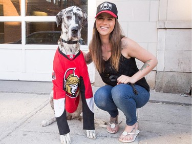 Morgan Leigh and her Great Dane "Biggest" along Clarence St as Sens fans pour onto the Sens Mile along Elgin St and the Sens Square in Byward Market to watch Friday's game between Montreal Canadiens and Ottawa Senators being played in Montreal.