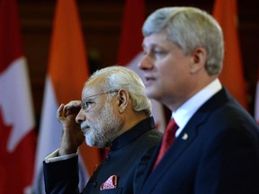 Indian Prime Minister Narendra Modi takes part in a joint press conference with Prime Minister Stephen Harper on Parliament Hill in Ottawa on Wednesday, April 15, 2015.