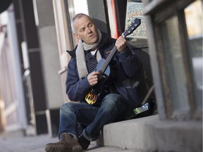 Ottawa Bluesfest executive director, Mark Monahan, "busks" on Bank St. Wednesday April 01, 2015.