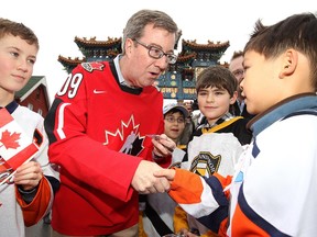 In 2010, Ottawa Mayor Jim Watson (pictured greeting a young Beijing player) and other dignitaries welcomed six of this year's participating teams in the Bell Capital Cup to  the recently opened Chinese Imperial Archway in Ottawa's Chinatown for a group photo. Three of the teams were from local minor hockey associations while the other three were from Beijing - Ottawa's sister city.