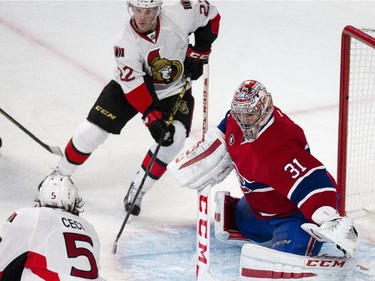 Ottawa Senators' Cody Ceci, left, shoots on Montreal Canadiens' goalie, Carey Price, while Erik Condra, top, looks for a rebound during the first period of NHL playoff action at the Bell Centre in Montreal Wednesday April 15, 2015.