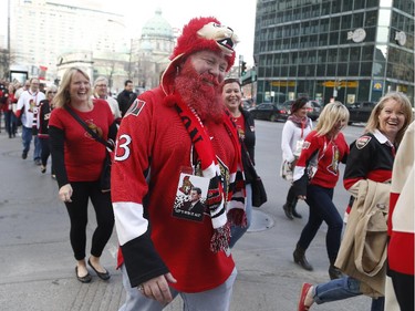 Ottawa Senators fan, David MacIsaac, walks with a group like-minded people to watch game two between the Ottawa Senators and Montreal Canadiens at the Bell Centre in Montreal Friday April 17, 2015.