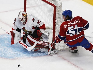 Ottawa Senators' goalie, Andrew Hammond, stops Montreal Canadiens' David Desharnais, 51, during the second period of NHL playoff action at the Bell Centre in Montreal Wednesday April 15, 2015.