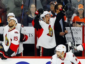 Ottawa Senators' Mark Stone raises his arms and shouts as the Senators empty the bench after defeating the Philadelphia Flyers in an NHL hockey game, Saturday, April 11, 2015, in Philadelphia. The Senators won 3-1.(AP Photo/Tom Mihalek)