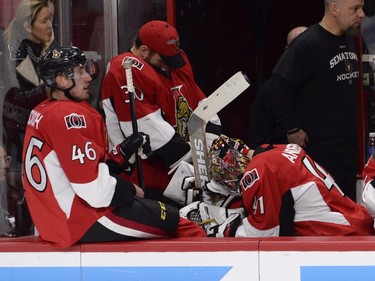 Ottawa Senators' Patrick Wiercioch (46) Andrew Hammond (30) and Craig Anderson (41) sit on the bench during third period NHL playoff action in Ottawa, Sunday, April 26, 2015.